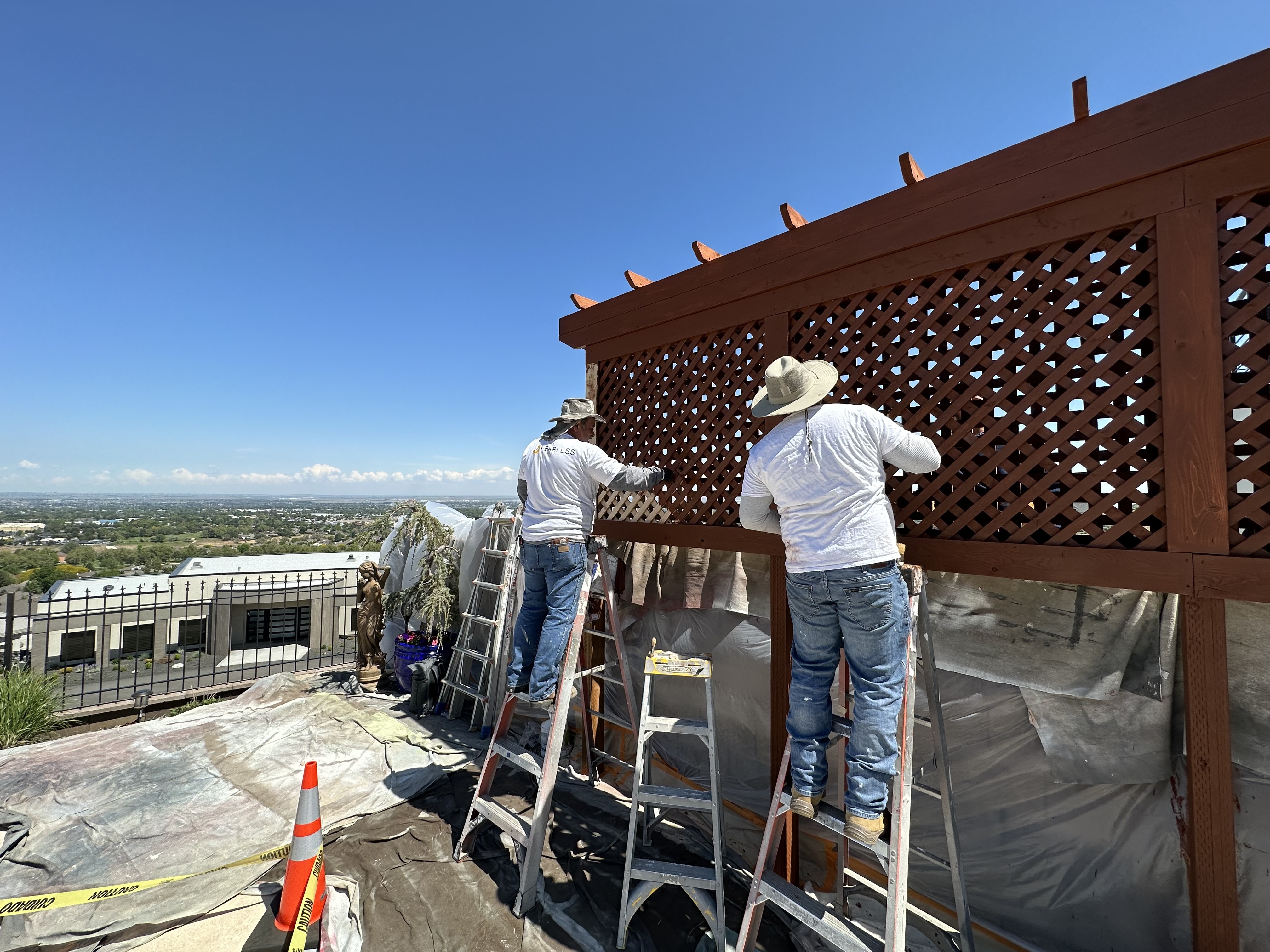 Two professional painters applying paint to an interior wall